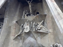 Detail of the crucifixion on the Passion facade.  This facade is starkly modern compared to the Nativity facade, reflecting both its later design in a more modern time and the events depicted.