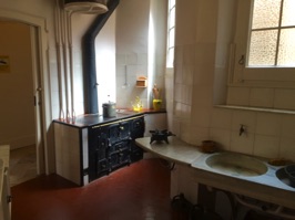 The kitchen looks spartan but was probably luxurious for the time.