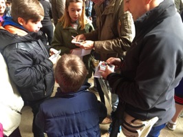 Kids abound trading cards of their favorite soccer players.