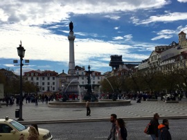 Rossio Square with monument to King Pedro IV in the center, dating from 1874. Pedro IV was also the first Emperor of Brazil. The Santa Justa lift is in the background vertically connecting lower Lisbon to an upper level of the city.
